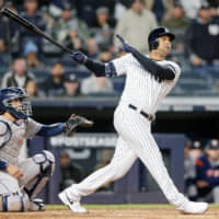New York's Aaron Hicks watches his three-run homer against Houston in the first inning of Game 5 of the ALCS on Friday night.