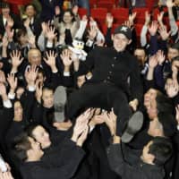 Pitcher Roki Sasaki is lifted up by his Ofunato High School classmates in Ofunato, Iwate Prefecture, on Thursday after the Chiba Lotte Marines selected him as the No. 1 pick in the NPB amateur draft. All 12 NPB teams nominate their first choice in secret, and the player's negotiating rights are decided by drawing lots.