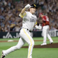 SoftBank's Seiichi Uchikawa celebrates after hitting the eventual game-winning home run against Rakuten on Monday at Yafuoku Dome.