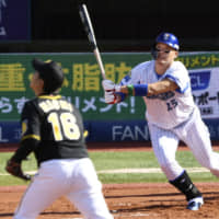 Yokohama BayStars left fielder Yoshitomo Tsutsugo hits a three-run homer against the Hanshin Tigers in Game 1 of the Central League Climax Series first stage on Saturday at Yokohama Stadium.