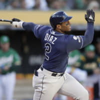 The Rays' Yandy Diaz hits a solo homer against the A's during the third inning on Wednesday in Oakland, California.
