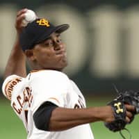 Yomiuri Giants starter C.C. Mercedes fires a pitch against the Hanshin Tigers on Thursday night at Tokyo Dome.