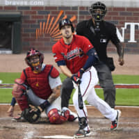 The Braves' Adam Duvall watches his two-run homer against the Cardinals in the seventh inning during Game 2 of the NLDS on Friday in Atlanta.