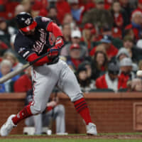 Washington's Howie Kendrick hits an RBI single against St. Louis in the seventh inning of Game 1 of the National League Championship Series on Friday.