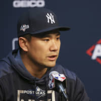 Yankees pitcher Masahiro Tanaka talks to the media on Friday in Houston.