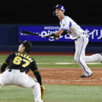 BayStars pinch-hitter Tomo Otosaka hits a game-ending two-run home run in the bottom of the ninth inning against the Tigers on Sunday at Yokohama Stadium. The Central League Climax Series first stage is tied at 1-1.