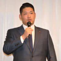 BayStars slugger Yoshitomo Tsutsugo speaks at a news conference at a Yokohama hotel on Tuesday. The 27-year-old announced his intention to go to the major leagues via the posting system this offseason.