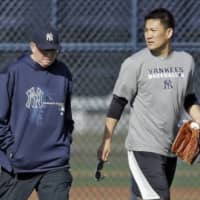 Yankees pitching coach Larry Rothschild (left), seen walking with hurler Masahiro Tanaka in February 2014 at spring training, was fired after nine seasons on Monday.