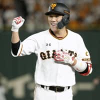 Giants infielder Hayato Sakamoto celebrates after driving in two runs with his second-inning single against the Tigers on Wednesday at Tokyo Dome.