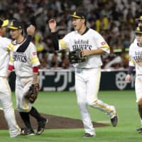 Hawks players celebrate their win over the Eagles on Sunday in Fukuoka.