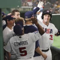 Brent Rooker is congratulated by U.S. teammates after hitting a two-run homer in the seventh inning against Taiwan in a Premier12 game on Friday at Tokyo Dome.