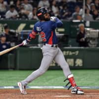 U.S. outfielder Jo Adell belts a solo homer in the seventh inning against Japan in a Super Round game at the Premier12 on Tuesday at Tokyo Dome.