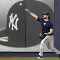 Astros pitcher Gerrit Cole throws on the field during a practice at Yankee Stadium on Oct. 14. Cole agreed to a contract with New York on Tuesday.