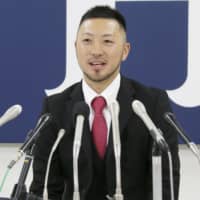 Carp second baseman Ryosuke Kikuchi speaks at a news conference on Friday in Hiroshima.