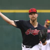 Indians starter Corey Kluber pitches during a spring training game against the Reds in Goodyear, Arizona, on March 11. Cleveland traded Kluber, a two-time Cy Young winner, to the Rangers on Sunday.