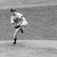 In an October 1952 file photo, Brooklyn Dodgers hurler Carl Erskine pitches against the New York Yankees in Game 5 of the World Series in New York.