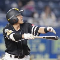 The Hawks' Yuki Yanagita hits a home run against the Marines on Saturday in Chiba. | KYODO
