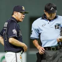 Orix manager Norifumi Nishimura, seen speaking to an umpire on July 28 in Sapporo, resigned following a loss Thursday. | KYODO