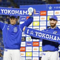 BayStars pitchers Spencer Patton (right) and Shoichi Ino celebrate during their hero interview on Thursday in Yokohama. | KYODO