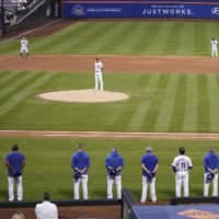 The Mets and Marlins stand on the field and bow their heads for a moment of silence before walking out without playing on Thursday in New York. | AP
