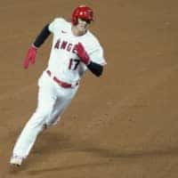 Angels designated hitter Shohei Ohtani runs to third base during the fifth inning against the Rangers on Saturday in Anaheim, California. | AP
