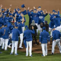The Blue Jays celebrate on the mount after clinching a playoff spot with a win against the Yankees on Thursday in Buffalo, New York. | USA TODAY / VIA REUTERS