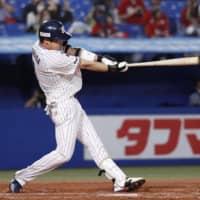 The Swallows' Tetsuto Yamada homers against the Carp during the first inning on Sunday at Jingu Stadium. | KYODO