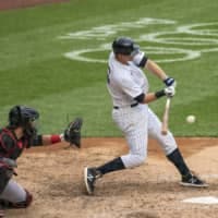 The Yankees' DJ LeMahieu hits a two-run double against the Marlins during the sixth inning on Saturday at Yankee Stadium. | AP