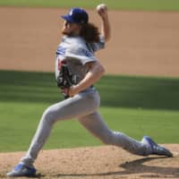 Dodgers pitcher Dustin May delivers against the Padres during the fifth inning of their game on Wednesday in San Diego. | AP