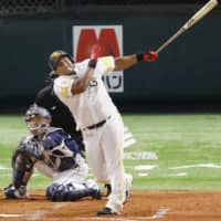 The Hawks' Alfredo Despaigne homers against the Lions on Friday in Fukuoka. | KYODO