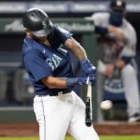 Seattle's Tim Lopes doubles against the Astros on Monday in Seattle. | AP