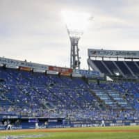 Fans watch a game between the BayStars and Dragons on Friday at Yokohama Stadium. | KYODO