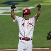The Reds' Shogo Akiyama celebrates after scoring the winning run against the Cardinals on Wednesday in Cincinnati. | AP