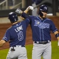 The Rays' Yoshitomo Tsutsugo (right) celebrates with teammate Brandon Lowe following Lowe's two-run home run against the Mets on Wednesday in New York. | AP