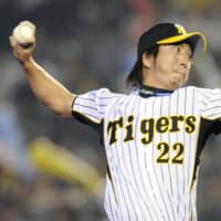 Hanshin's Kyuji Fujikawa recorded his 100th save on Sept. 25 at Koshien Stadium in Nishimomiya, Hyogo Prefecture. | KYODO