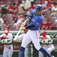 Takayuki Kajitani homers against the Carp on Sunday in Hiroshima. | KYODO