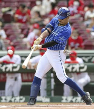 Takayuki Kajitani homers against the Carp on Sunday in Hiroshima. | KYODO