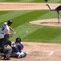 Chicago's Jose Abreu swings into a home run off Twins starting pitcher Kenta Maeda during the fourth inning on Thursday in Chicago. | AP