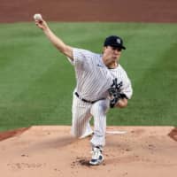 Yankees starting pitcher Masahiro Tanaka throws against the Rays on Tuesday in New York. | USA TODAY / VIA REUTERS