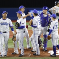 BayStars players celebrate after earning a third straight win over the Giants on Thursday in Yokohama. | KYODO