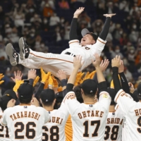 Giants manager Tatsunori Hara is given a doage (victory toss) after the team's pennant-clinching win on Friday at Tokyo Dome. | KYODO