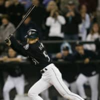 Seattle's Ichiro Suzuki of Japan hits a single against the Rangers for his 258th hit of the season, surpassing George Sisler's record, on Oct. 1, 2004, in Seattle. | REUTERS