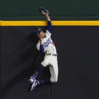 Dodgers right fielder Mookie Betts robs the Braves' Freddie Freeman of a home run during the fifth inning in Game 7 of the NLCS on Sunday in Arlington, Texas. | AP