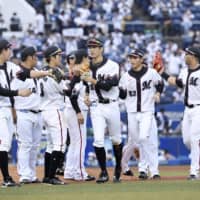 Marines players celebrate a win against Seibu on Sunday in Chiba. Lotte's Tuesday game against the Buffaloes is scheduled to go on despite several people in the organization testing positive for the coronavirus. | KYODO