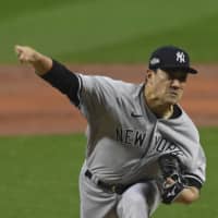 Yankees starter Masahiro Tanaka pitches against the Indians during Game 2 of their AL wild-card series in Cleveland on Wednesday. | AP