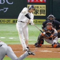 Yuki Yanagita homers against the Giants in Game 4 of the Japan Series on Wednesday. | KYODO