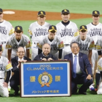 The Hawks pose for a team photo after advancing to the Japan Series with a PL Climax Series-clinching win over the Marines on Sunday in Fukuoka. | KYODO