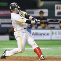 The Hawks' Takuya Kai connects on a two-run home run against the Giants during the second inning on Wednesday in Fukuoka. | KYODO