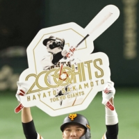 Giants shortstop Hayato Sakamoto celebrates on the field after recording the 2,000th hit of his career at Tokyo Dome on Sunday. | KYODO