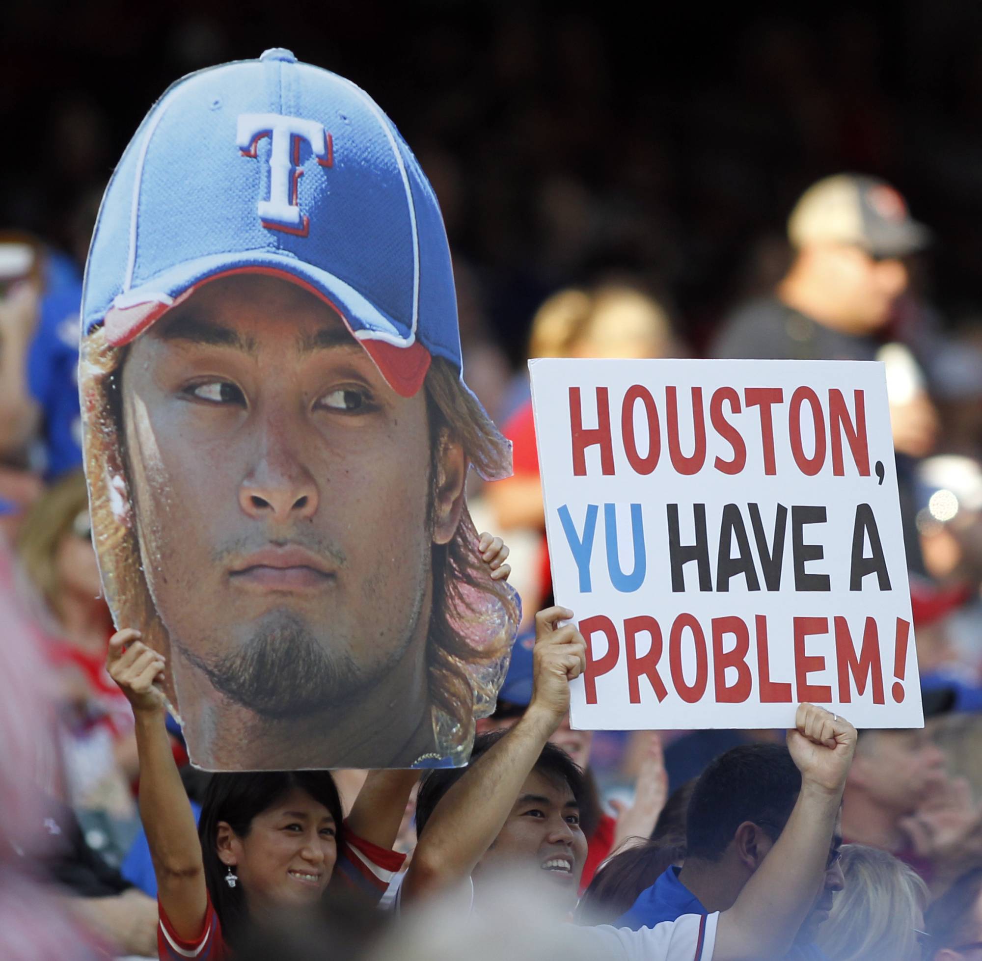Fans hold signs supporting Rangers starting pitcher Yu Darvish before a game against the Astros in Arlington, Texas, on June 15, 2012. | REUTERS